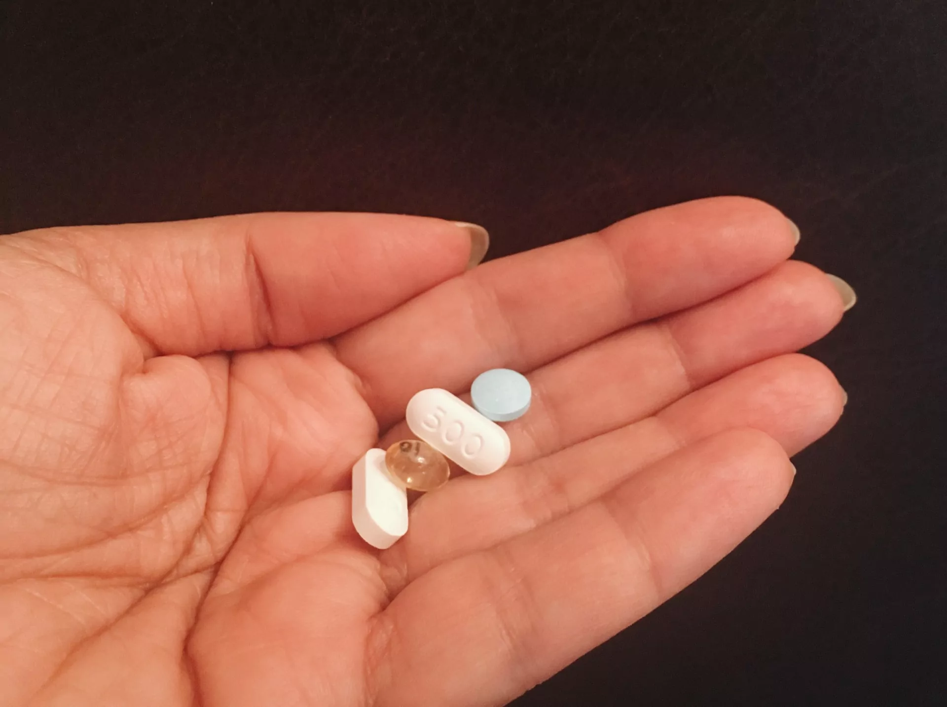 Tabletki poronne na otwartej dłoni kobiety